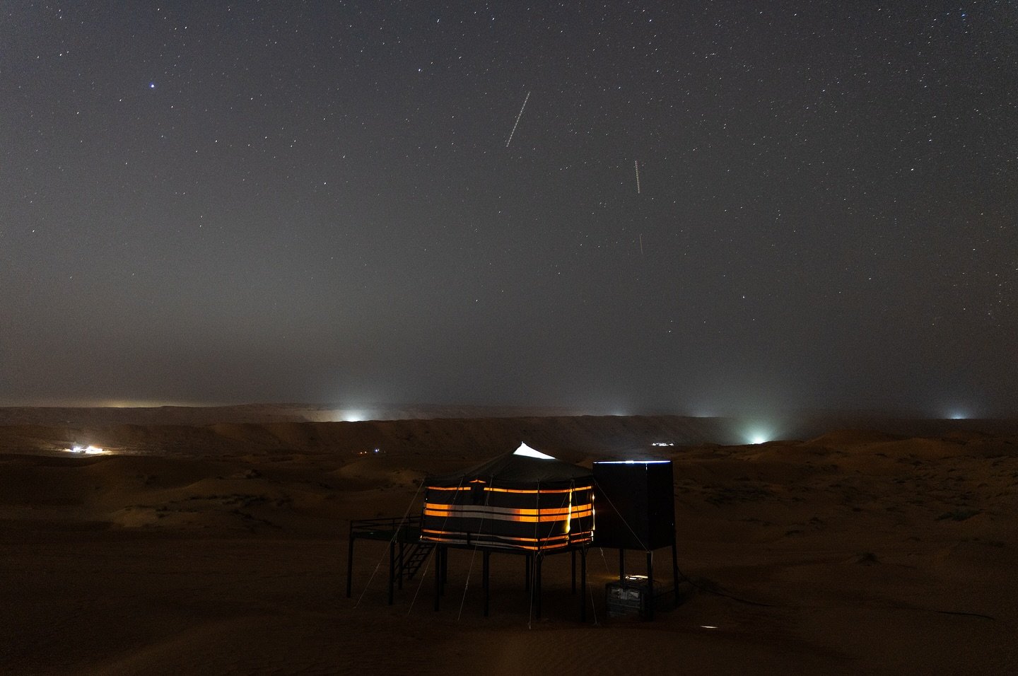 This photo captures a night view of a lit-up tent in a tourism spot in Bidiyah, Oman. @Roy Issa